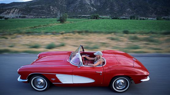 A younger driver in a collector car.